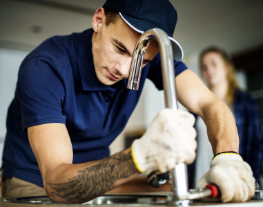 plumber-fixing-kitchen