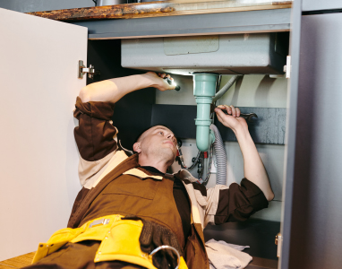 young-plumber-fixing-new-pipe-with-wrench